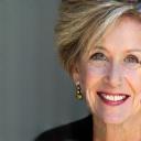 Headshot of Eleanor Vance, a smiling an elegant woman in her 40s.